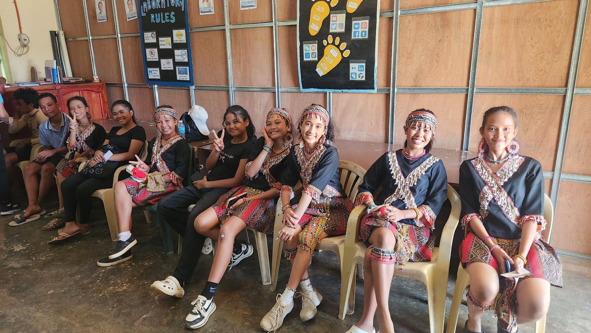 Students in traditional dress smiling for the OEBB mission team
